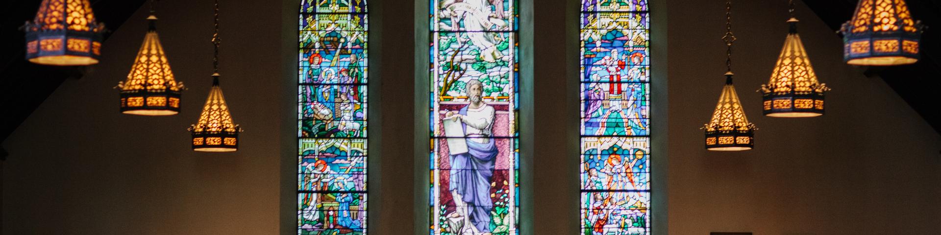 Three stained glass windows in a church 