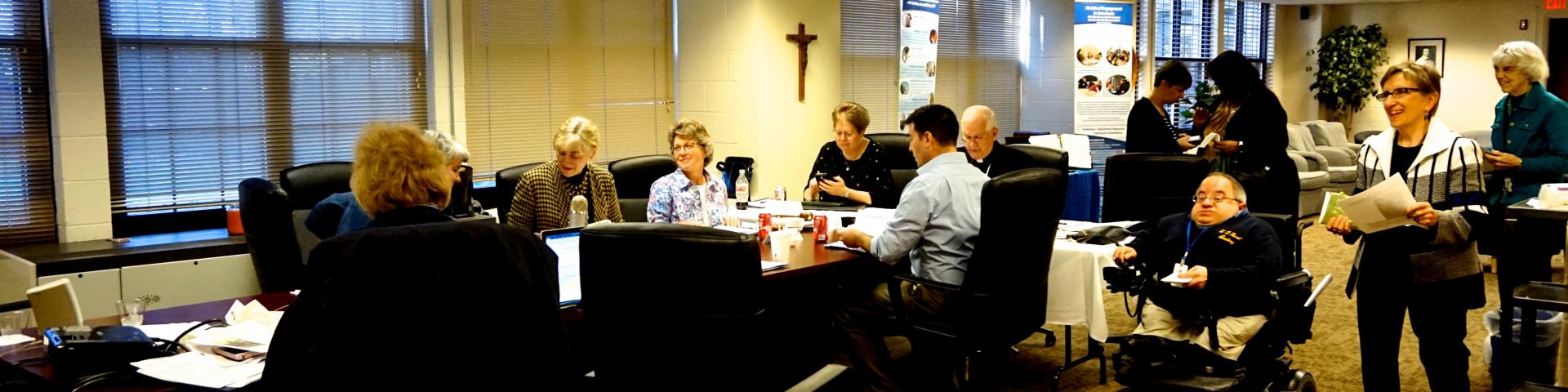 NCPD Board of Directors at a conference table preparing for a Board Meeting 