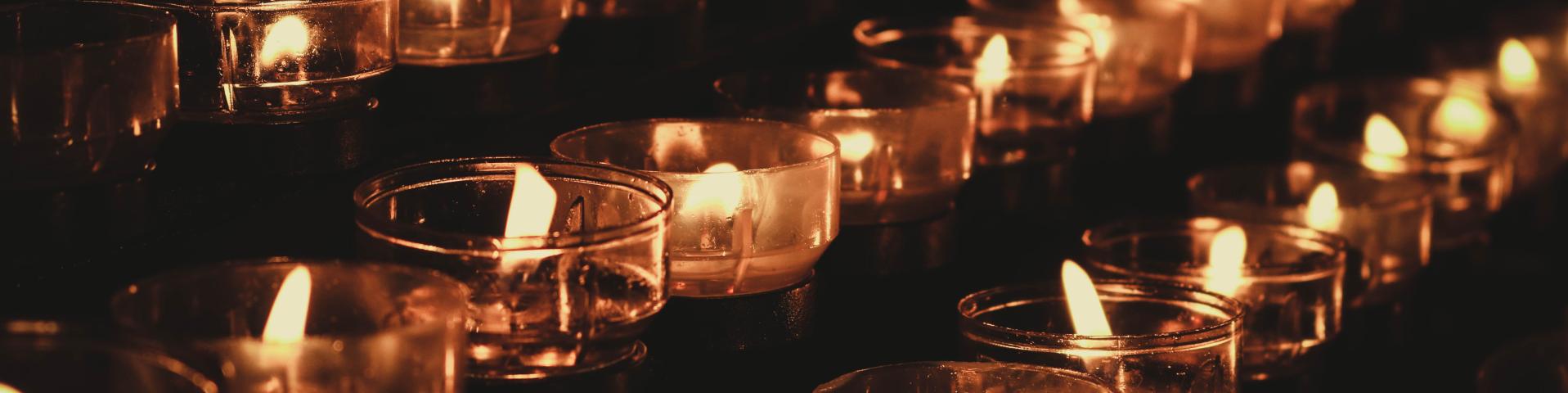 Rows of votive candles.