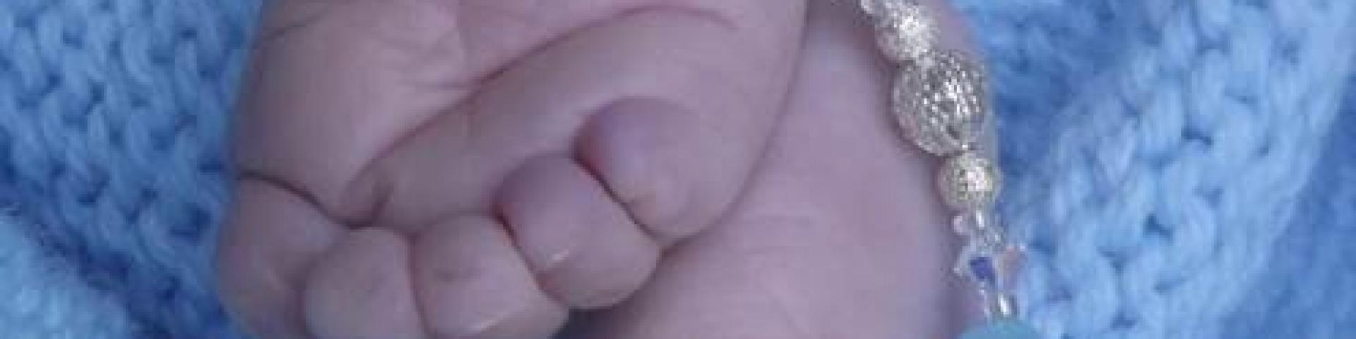 Baby's feet with rosary 