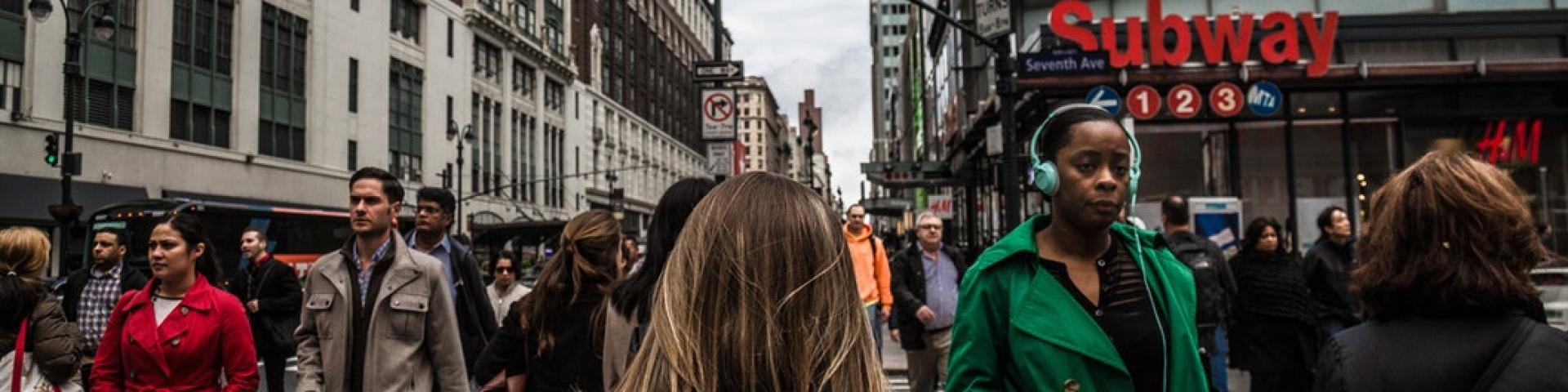 People walking around on a busy street