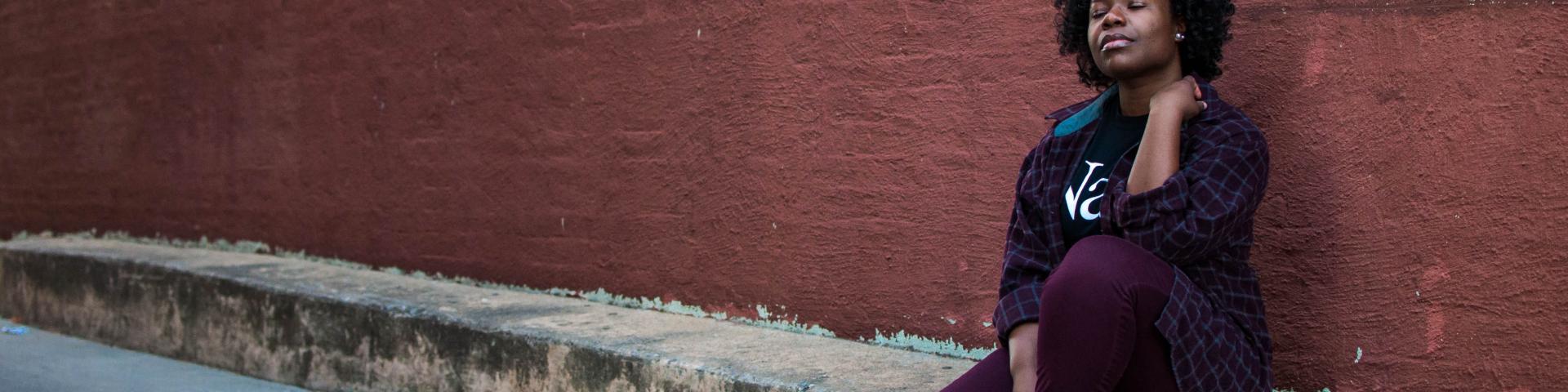 Woman sitting on a curb