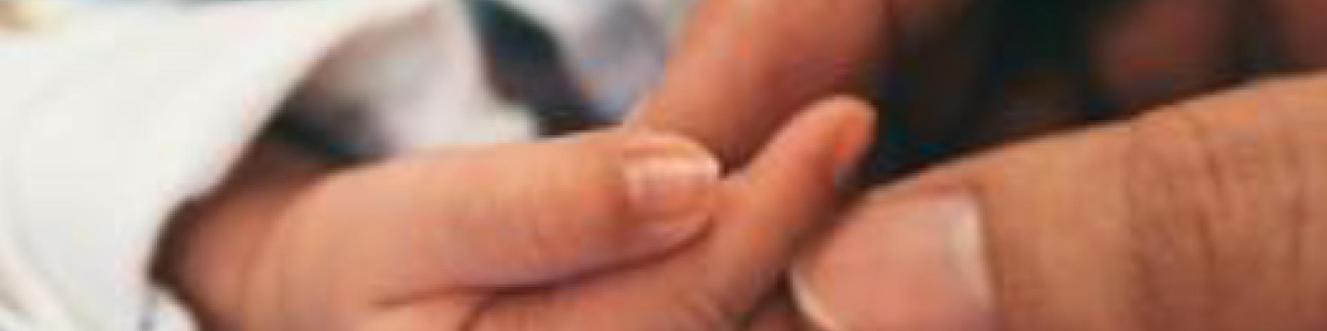 mom holding baby's hands