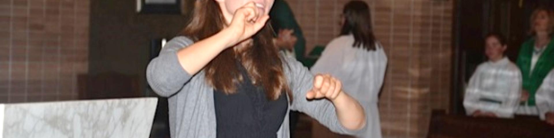 Young woman signing for a Mass