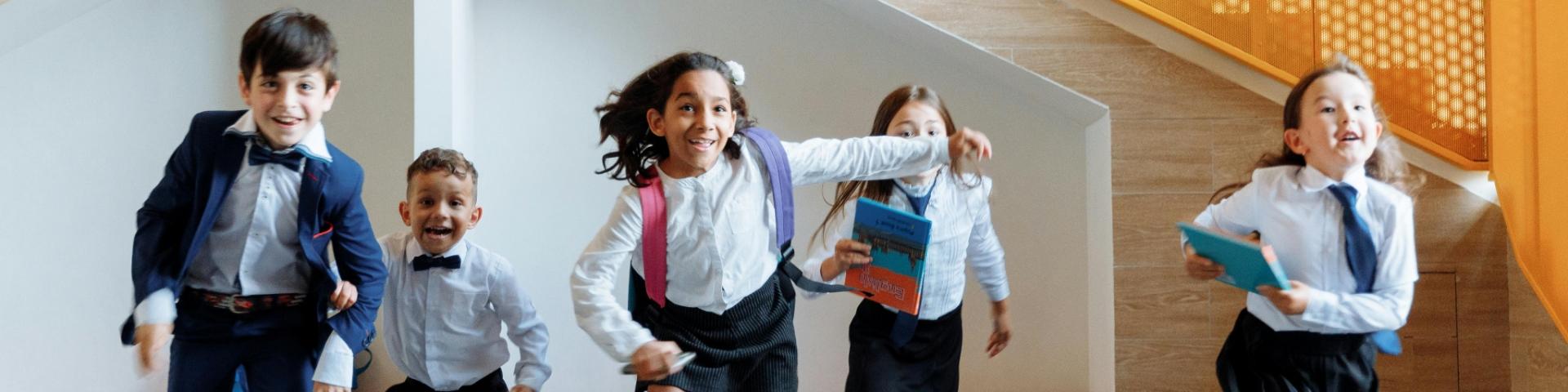 Kids in uniform running towards camera