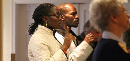 Two people signing at Mass 