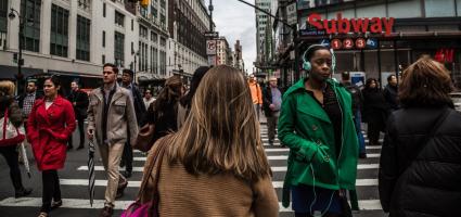 People walking around on a busy street 