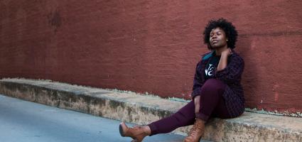 Woman sitting on a curb