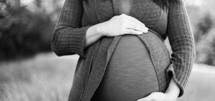 Black and white photo of a pregnant woman