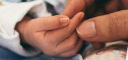 mom holding baby's hands