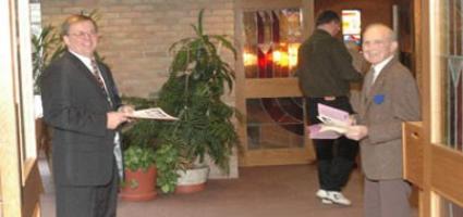 Ushers greeting at church door.