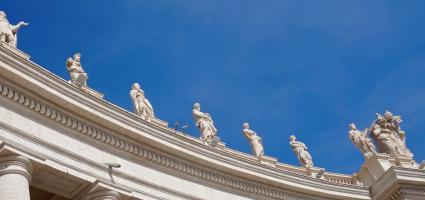 Vatican sculptures of saints with blue sky in the background