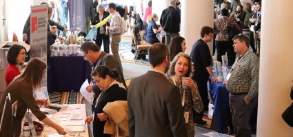 Picture of people networking in an exhibit hall at the Catholic Social Ministry Gathering 