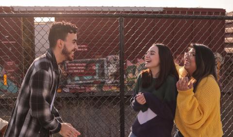 3 Teenagers socializing outside of their school