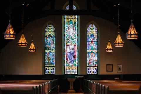 Dark church with stained glass windows
