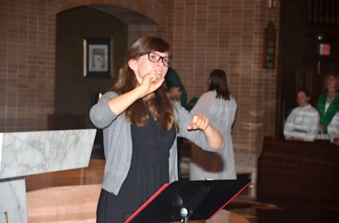 Young woman signing for a Mass