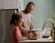 Father and daughter washing hands 