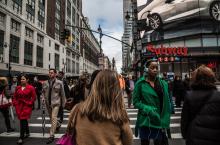 People walking around on a busy street 