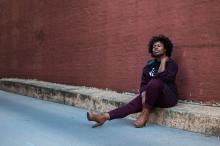 Woman sitting on a curb