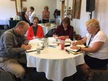 Four people working at a table during a conference