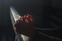 A person's hands folded in prayer 