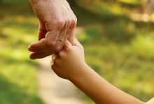 Parent holding the hand of their child 