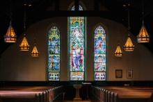 Dark church with stained glass windows