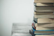 pile of books on a table off-center to the right 