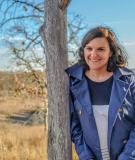Michele Chronister leaning against a tree