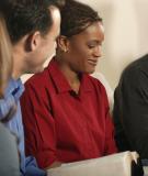 Person reading in a group with other parishioners