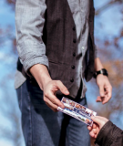 person handing an invitation to someone 